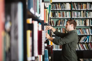 Looking at books on the shelves