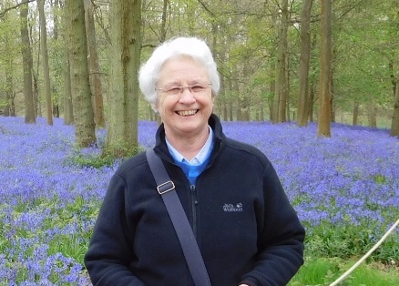 victoria hummell in a wood surrounded by bluebells
