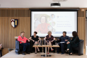 Sarah Franklin, Emily Jackson, Susan Michie, Dorothy Bishop and Helena Rodriguez Caro seated on the stage under an image of Anne McLaren on the large screen
