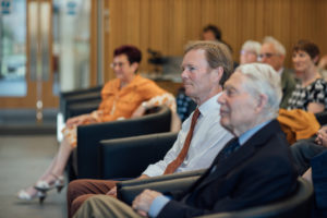 Kellogg President Jonathan Michie seated watching the lecture with other members of the audience