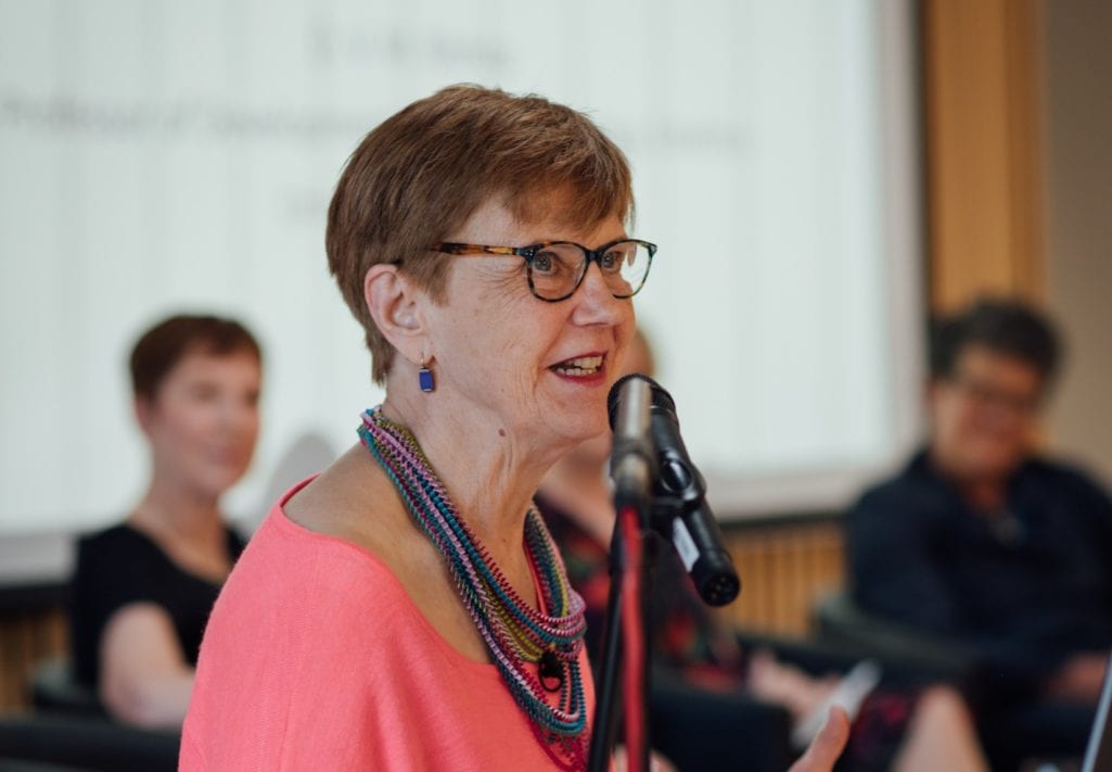 Dorothy Bishop speaking into the microphone at the lectern