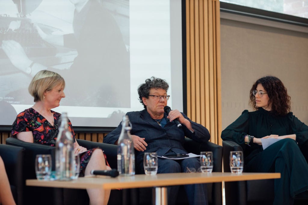 Sarah Franklin seated on the stage answering questions with Emily Jackson and Helena Rodriguez Caro