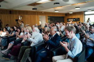 view of the audience from the side applauding