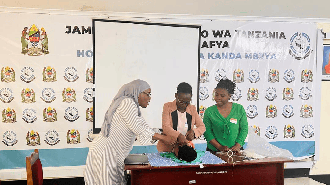 Zaitun (TZ consultant paediatric surgeon) demonstrating newborn care