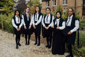 Group shot of students stood in front of college orchard