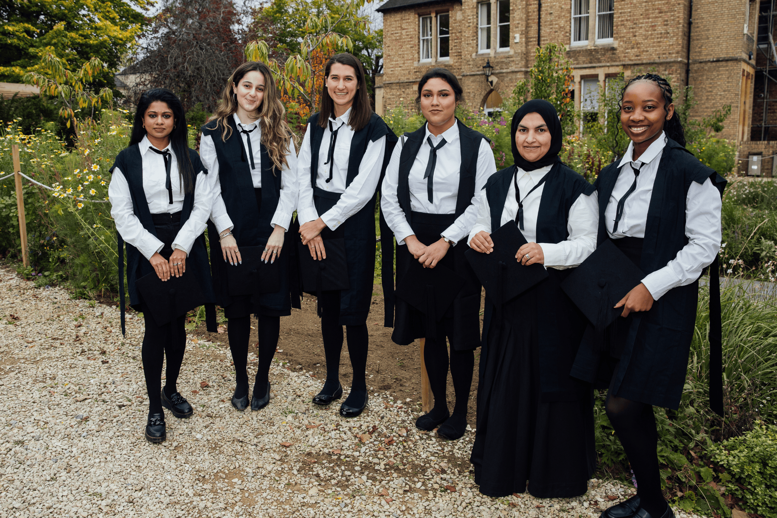 Group shot of students stood in front of college orchard
