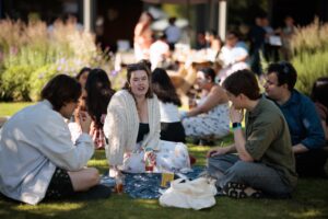 Guests chatting and enjoying refreshments in the College gardens.