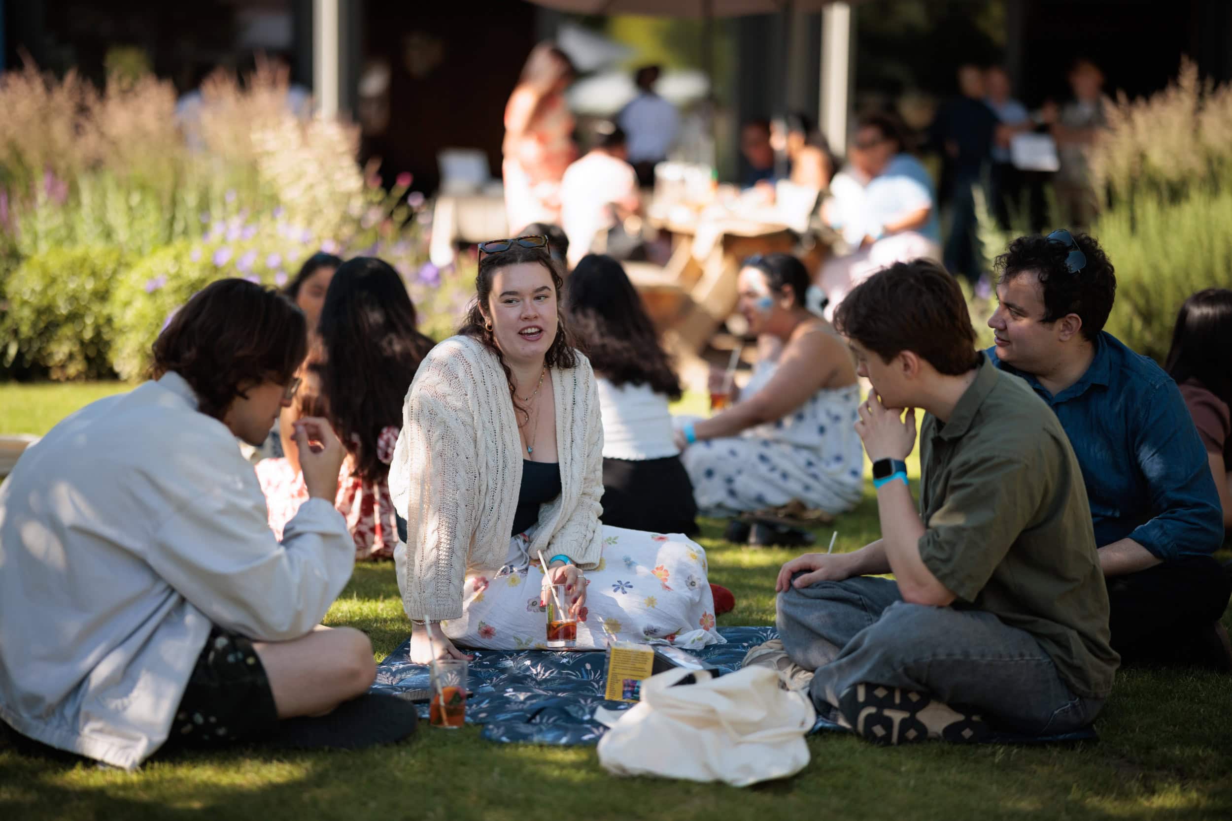 Guests chatting and enjoying refreshments in the College gardens.