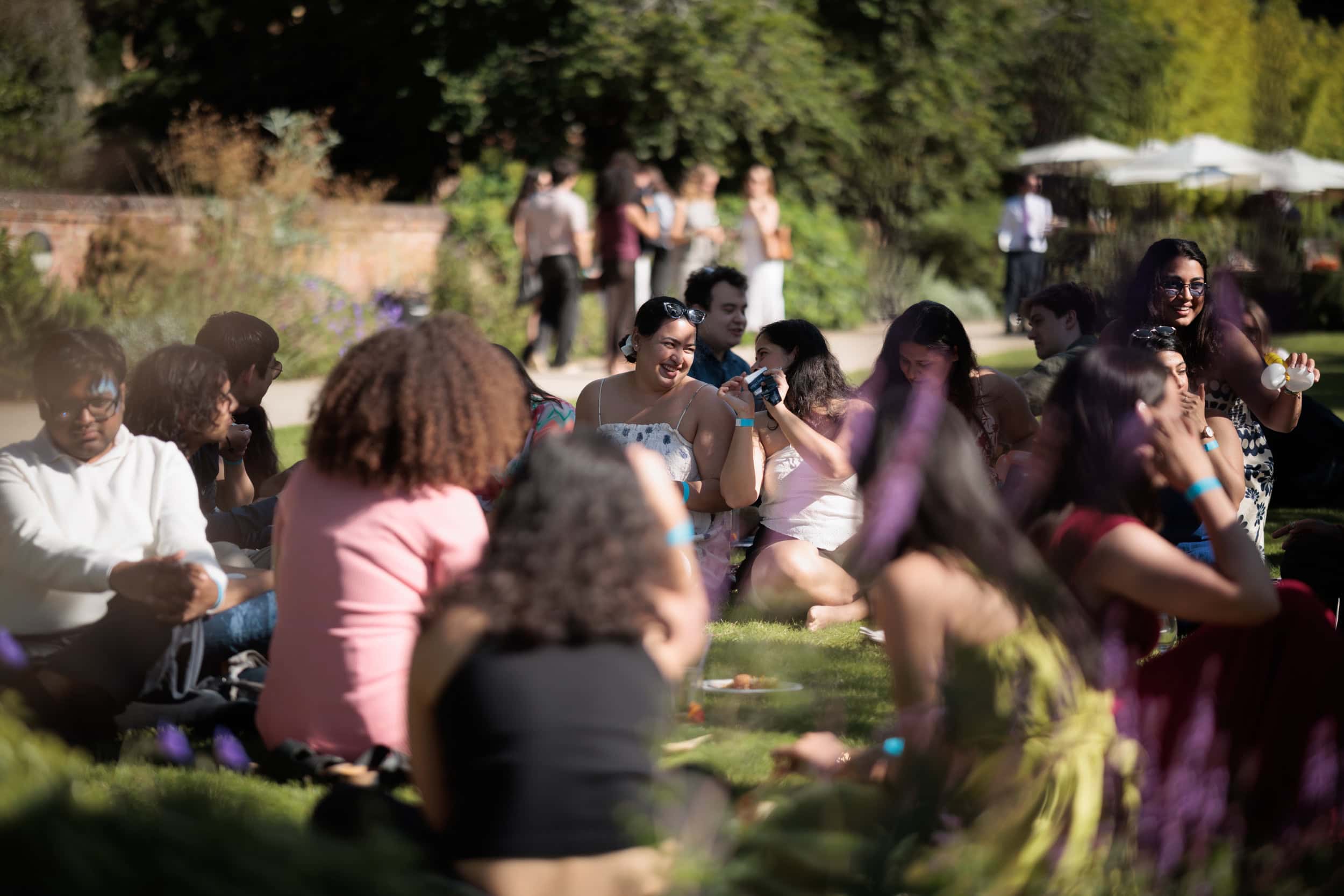 Guests relaxing on the lawn during the Summer Garden Party.