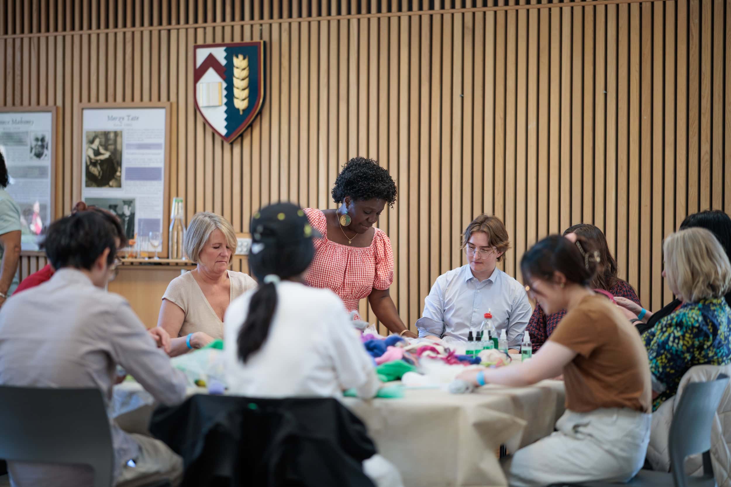 Families and children gathered around a table for crafts and activities.