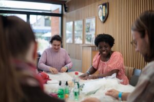Guests taking part in a craft activity inside the College.