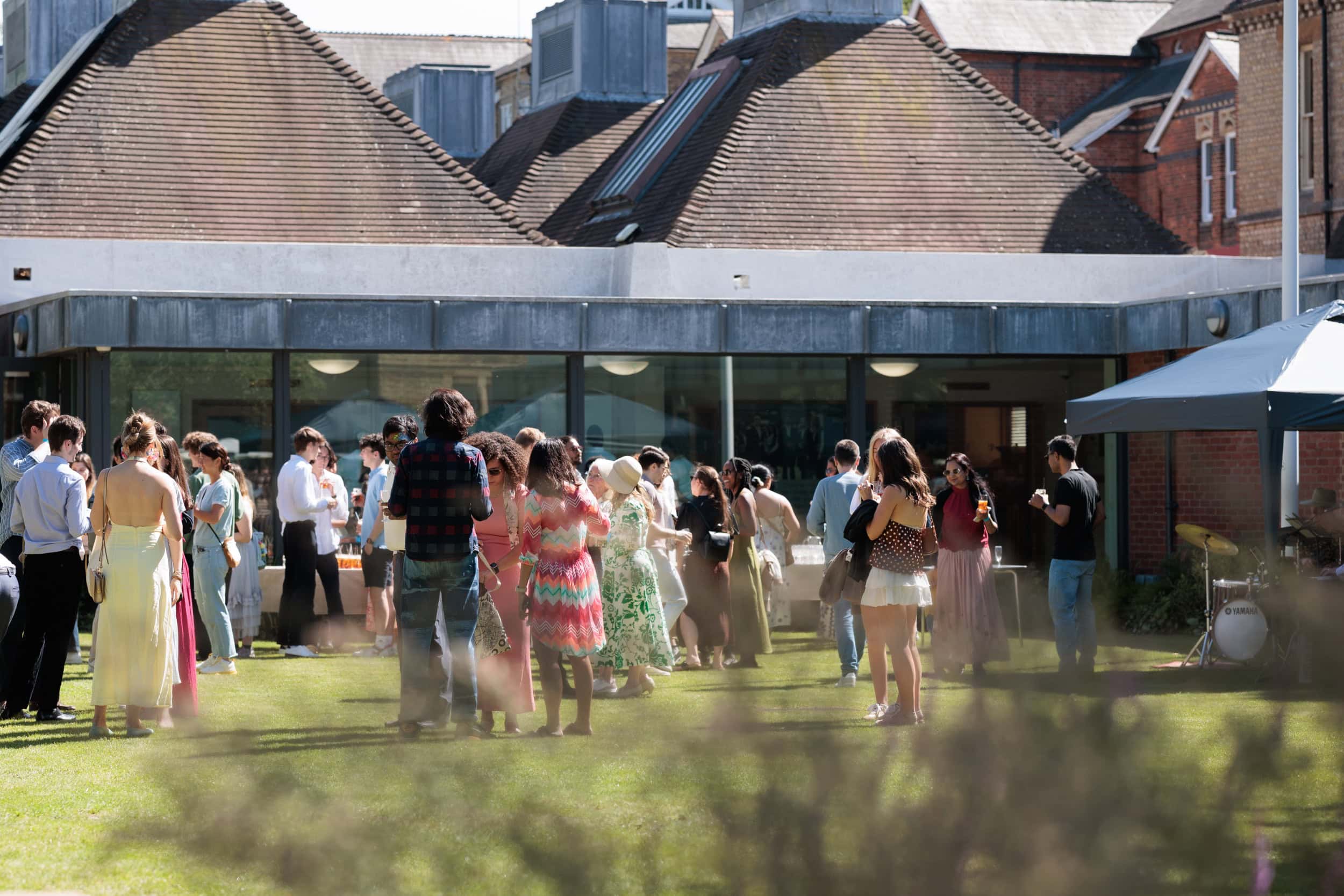 Guests relaxing on the lawn during the Summer Garden Party.
