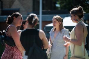 Guests chatting and enjoying refreshments in the College gardens.
