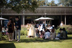 Guests relaxing on the lawn during the Summer Garden Party.