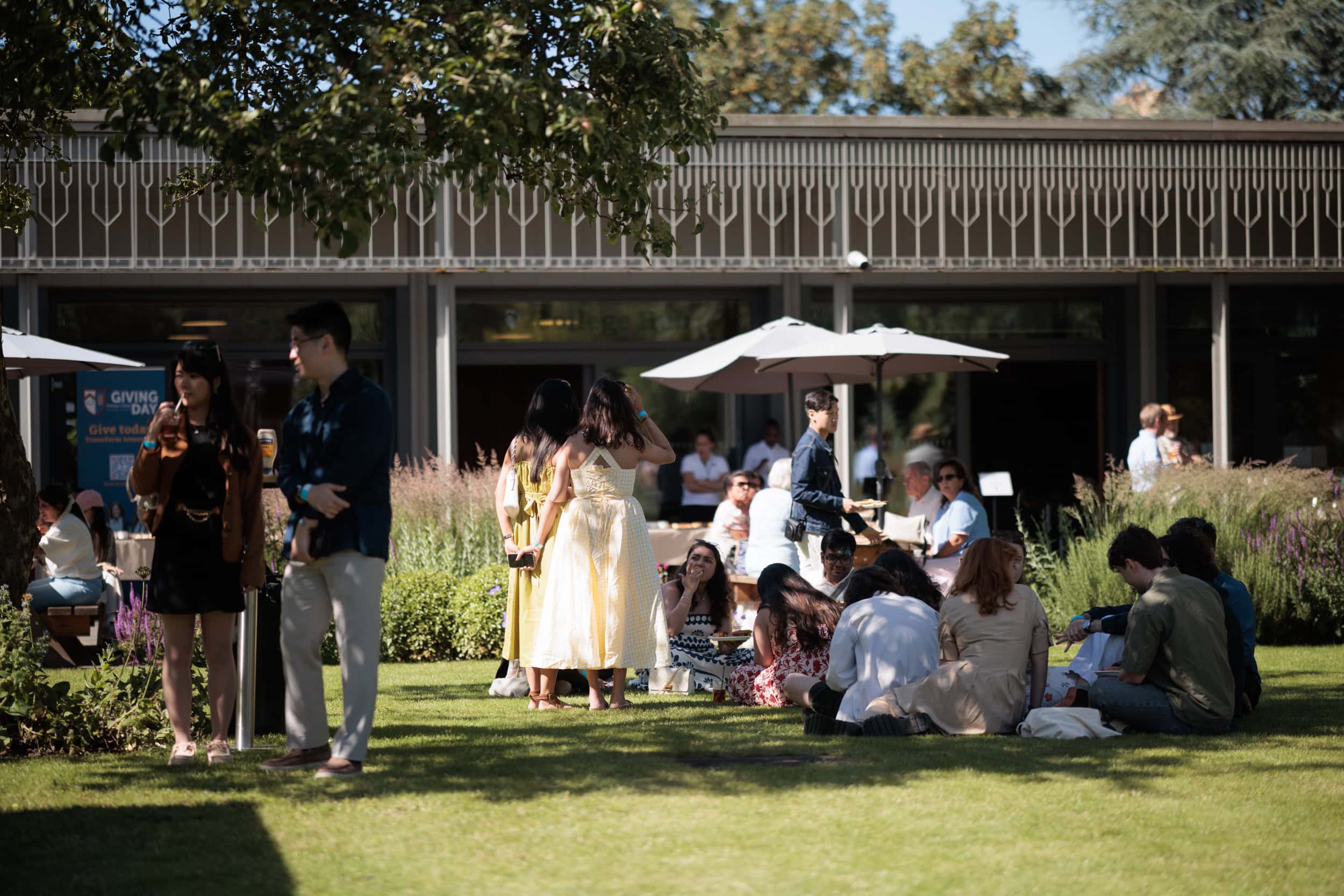Guests relaxing on the lawn during the Summer Garden Party.