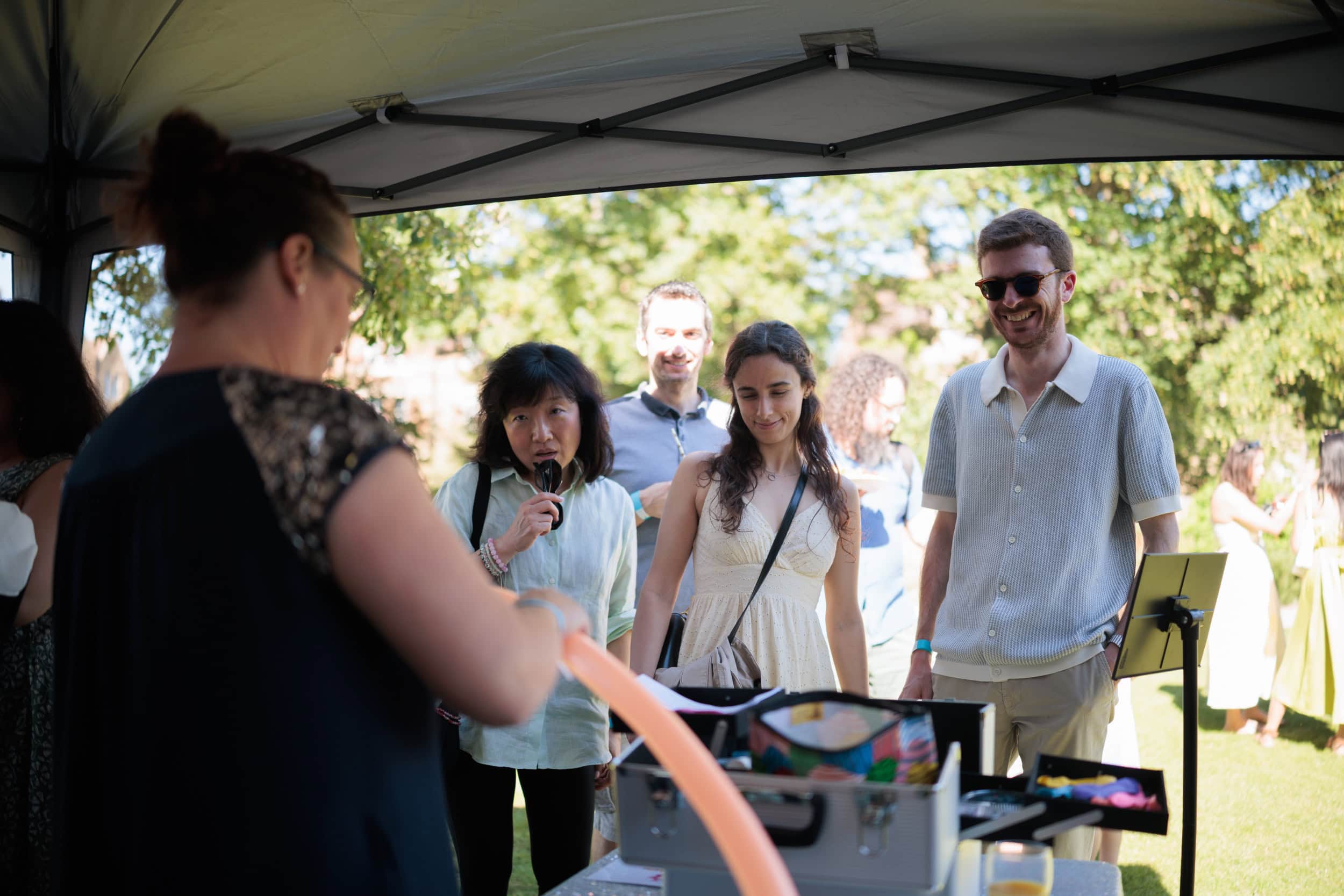 Guests chatting and enjoying refreshments in the College gardens.